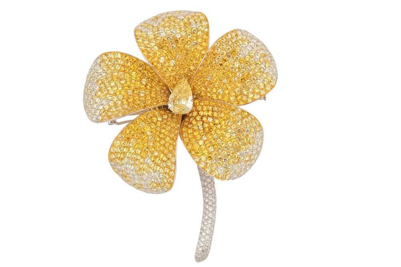 A yellow sapphire and diamond floral brooch