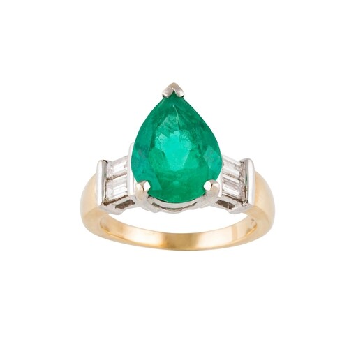 AN EMERALD AND DIAMOND RING, the pear shaped emerald to bagu...