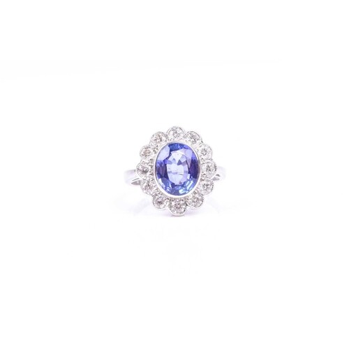 An 18ct white gold, diamond, and tanzanite cluster ring, set...