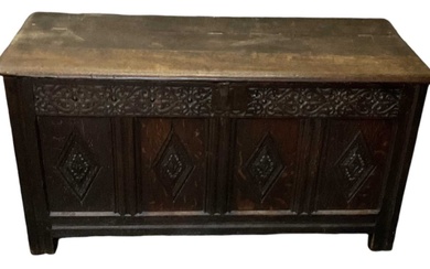An 18th century carved oak coffer, with hinged lid and...