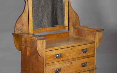 An Edwardian Arts and Crafts oak dressing chest, fitted with a swing mirror and two drawers, height
