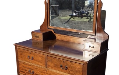 An Edwardian chequer strung mahogany dressing table, the arched bevelled...