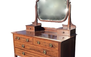 An Edwardian satinwood crossbanded mahogany dressing table, the bevelled mirror...