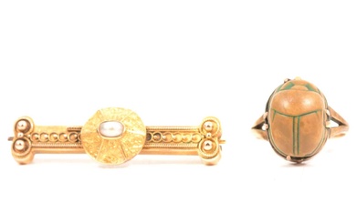 An Etruscan bar brooch and scarab ring.