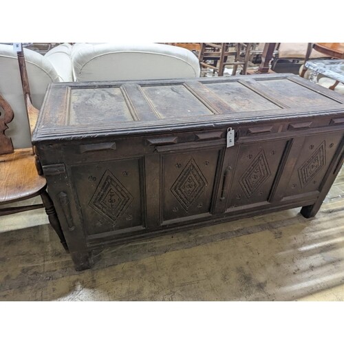 An early 18th century oak coffer, with four panel top and la...