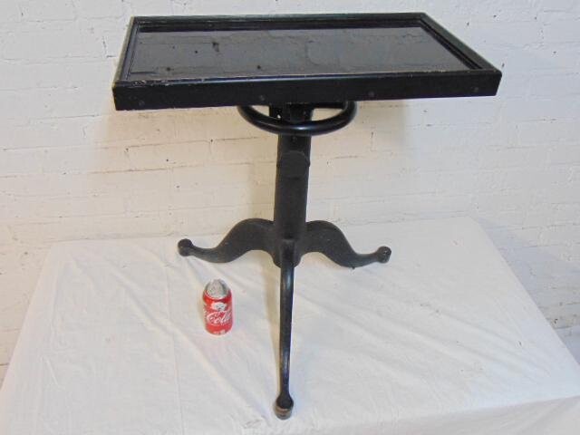 Cast iron base architects table, black glass top in