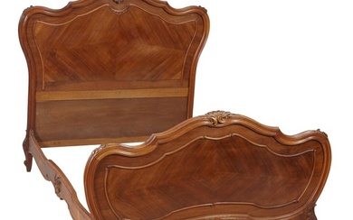 French Louis XV Style Carved Walnut Bed, 20th c., the elaborate rocaille crest over spurred shaped