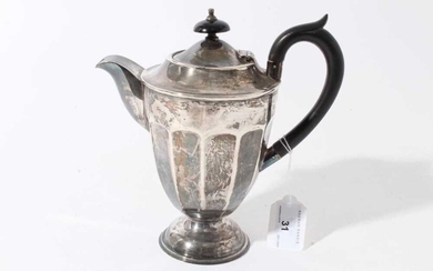 George V silver hot water jug of tapered form with faceted decoration, ebony finial and loop handle, raised on circular foot, (Sheffield 1931) maker Viners Ltd