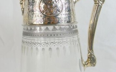 High quality and finely chased silver and glass claret jug by Elkington with clear hallmarks for Sheffield 1880. The silver lid, collar and handle have very finely chased decoration with a dog crest and satyr mask below the pouring spout. Elegant...