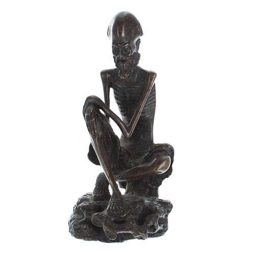 Japanese bronze figure of a skeletal man, cast seated upon a...