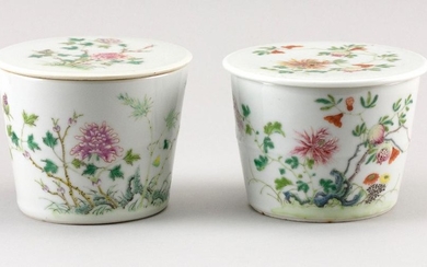 PAIR OF CHINESE FAMILLE ROSE PORCELAIN COVERED JARS In tapered cylindrical form, with enameled peony and pomegranate decoration. Six...