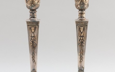 PAIR OF TOPAZIO SILVER PLATED CANDLESTICKS Neoclassical style, decorated with bunting, rams' heads and husk garlands. Weighted bases..