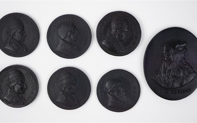 SIX WEDGWOOD BLACK BASALT CIRCULAR PAPAL MEDALLIONS AND AN OVAL PORTRAIT MEDALLION OF LEONARDO DA VINCI (1452-1519)