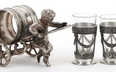 Silver plated napkin holder in the form of a boy pulling a c...