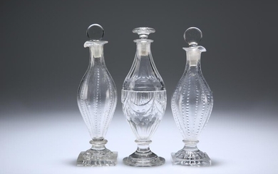 THREE ENGLISH GLASS CONDIMENT BOTTLES AND STOPPERS