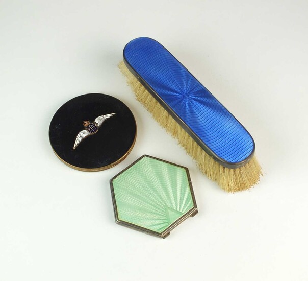 Two compacts and a clothes brush
