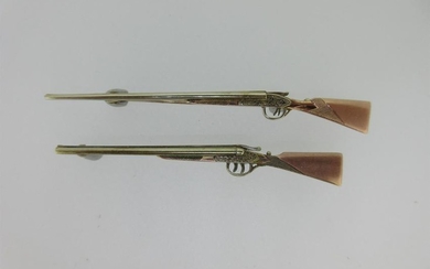 Two tricolour gold double barrelled shotgun brooches