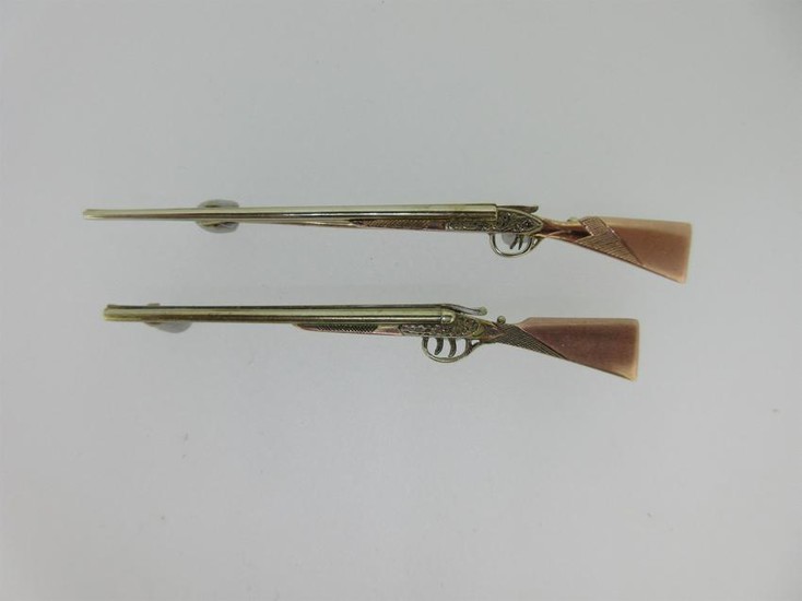 Two tricolour gold double barrelled shotgun brooches
