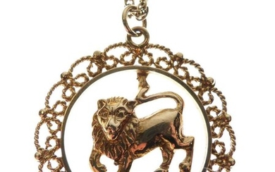 Unmarked yellow metal pendant, possibly Indian, depicting a lion...