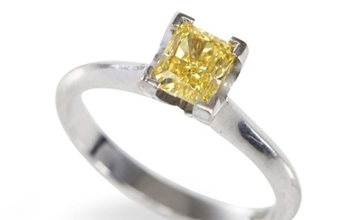 A YELLOW DIAMOND RING BY PAUL BRAM-Centrally set with a rectangular cut yellow diamond weighing 0.84cts, in 18ct white gold, ring si...