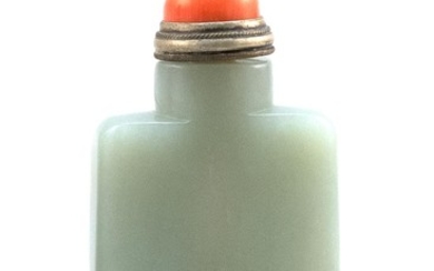 CHINESE CELADON AND RUSSET JADE SNUFF BOTTLE In rectangular form, with russet inclusions at foot. Height 2.6". Coral stopper.
