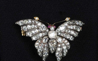 A late Victorian silver and gold, old-cut diamond butterfly brooch, with ruby eyes.