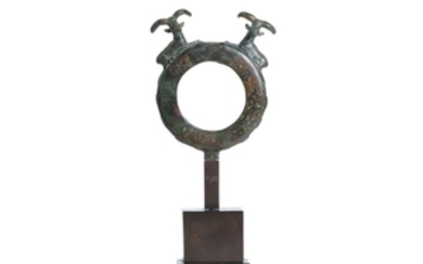 A NEAR EASTERN BRONZE RING ATTACHMENT WITH IBEX...