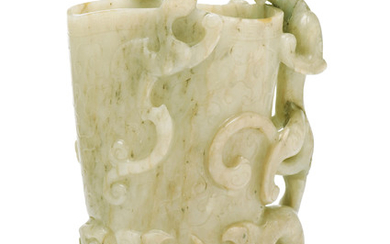 A PALE GREENISH-WHITE AND RUSSET JADE RHYTON, GUANG, 17TH-18TH CENTURY