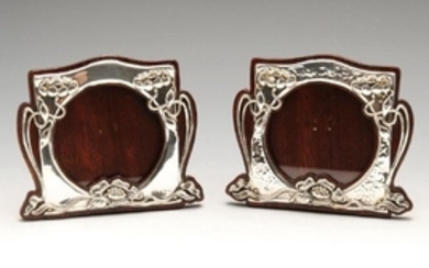 A pair of similarly matched Art Nouveau silver mounted