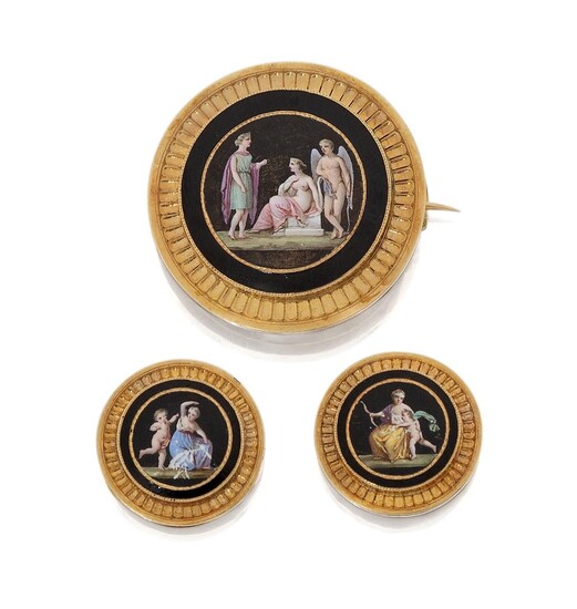 A 19th century French gold and painted Swiss enamel circular brooch, with two cloak buttons, each depicting a classical figure in polychrome enamel within black enamel and gold border, French assay marks for gold, approx. width of brooch 3.2cm, in...