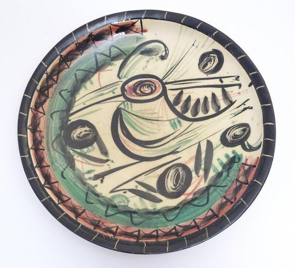 A 20thC studio pottery charger with hand painted