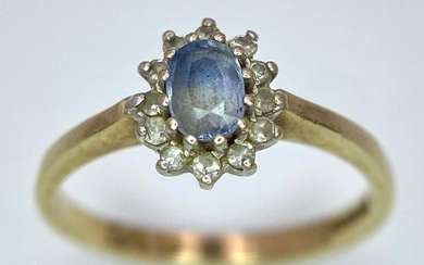A 9K Yellow Gold Aquamarine and Diamond Ring. Central...