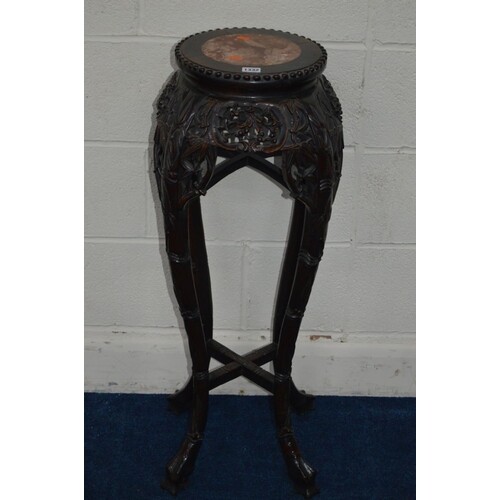 A CHINESE HARDWOOD CIRCULAR JARDINIERE STAND with a veined m...