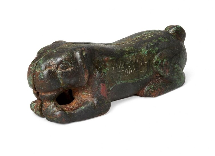 A Chinese bronze and silver-inlay two-piece tiger tally, hu-fu, Ming dynasty, 17th century, cast as a recumbent tiger in two parts with a silver-inlaid inscription to the exterior, 7.5cm long