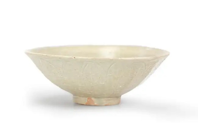 A Chinese celadon-glazed carved lotus bowl Song / Yuan dynasty carved to...