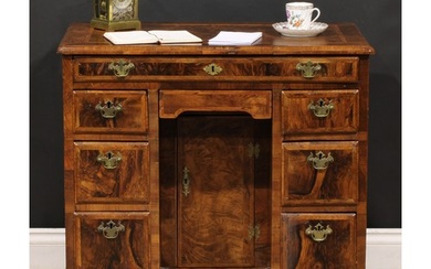 A George II featherbanded walnut kneehole desk, rectangular ...