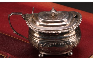 A George IV silver boat shaped mustard, hinged cover, gadroo...
