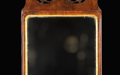 A Georgian Mahogany & Parcel Gilt Wall Mirror. The bevel-edged glass with re-entrant upper corners s
