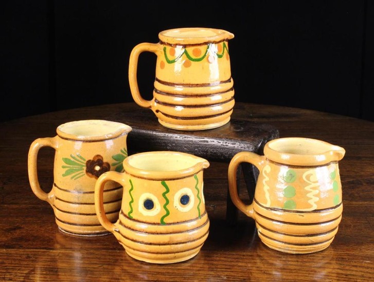 A Group of Four 19th Century French Country Slip-ware Jugs naively decorated with flowers, dots, sca