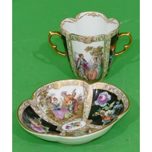 A Meissen Dresden Oval 2 Handled Cup with matching saucer on...