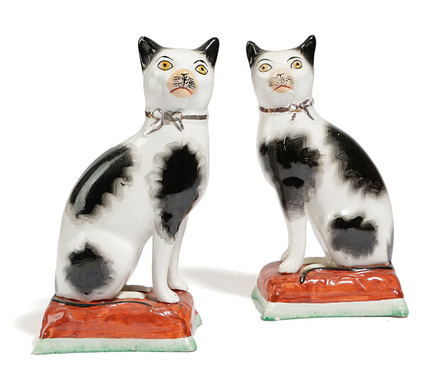A PAIR OF STAFFORDSHIRE POTTERY MODELS OF CATS