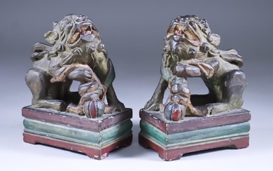 A Pair of Chinese Stoneware Fu Lions, each modelled...
