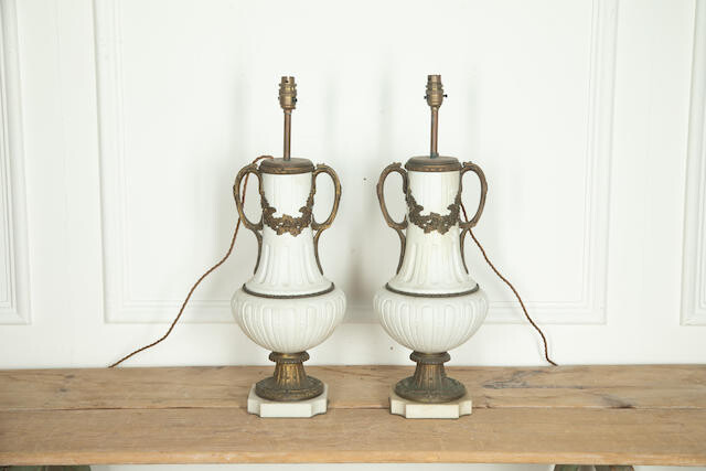 A Pair of French white ceramic and gilt metal mounted lamp bases