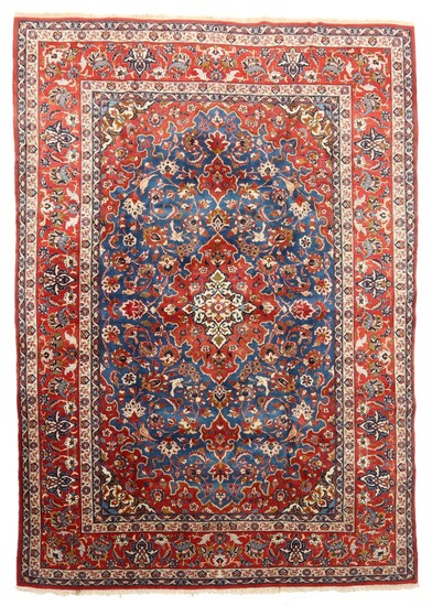 A Persian Isfahan carpet, classic medallion design on blue base. 20th century. 363×263 cm.