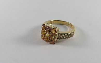 A SYNTHETIC YELLOW SAPPHIRE AND GOLD-PLATED SILVER RING