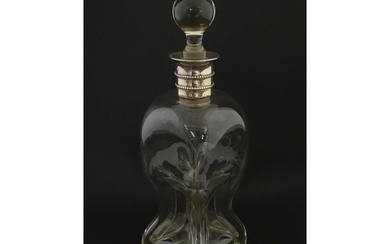 A Victorian glass decanter with pinch detail and silver coll...