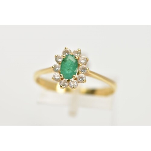 A YELLOW METAL EMERALD AND CUBIC ZIRCONIA CLUSTER RING, cent...