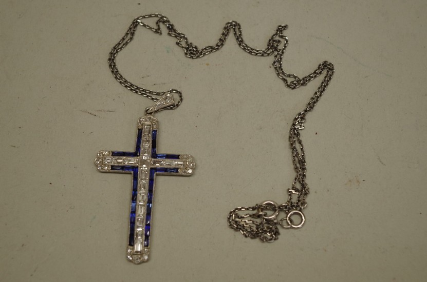 A diamond and sapphire encrusted unmarked cross pendant, hav...