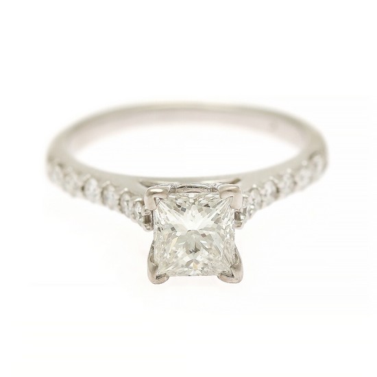 A diamond ring set with a princess-cut diamond weighing app. 0.95 ct. flanked by numerous diamonds, mounted in 18k white gold. Size 51.