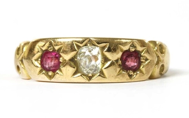 A gold diamond and ruby three stone ring